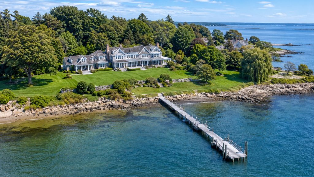 Aerial drone photo of a Fairfield County waterfront home with private dock and shoreline