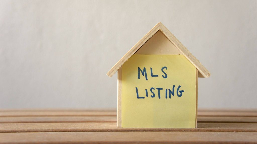 A house model with the text saying MLS Listing