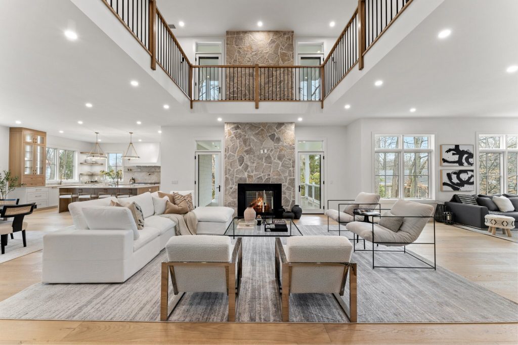 An interior shot of a large lounge with balcony and fireplace