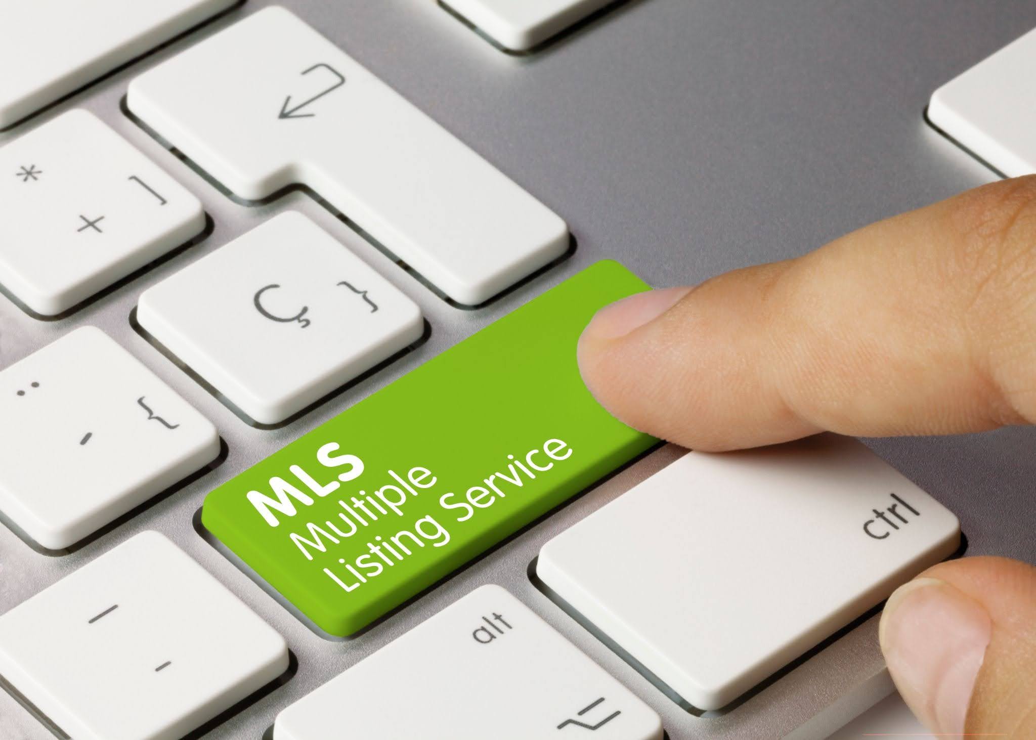 A multiple listing service inscription on a green keyboard key