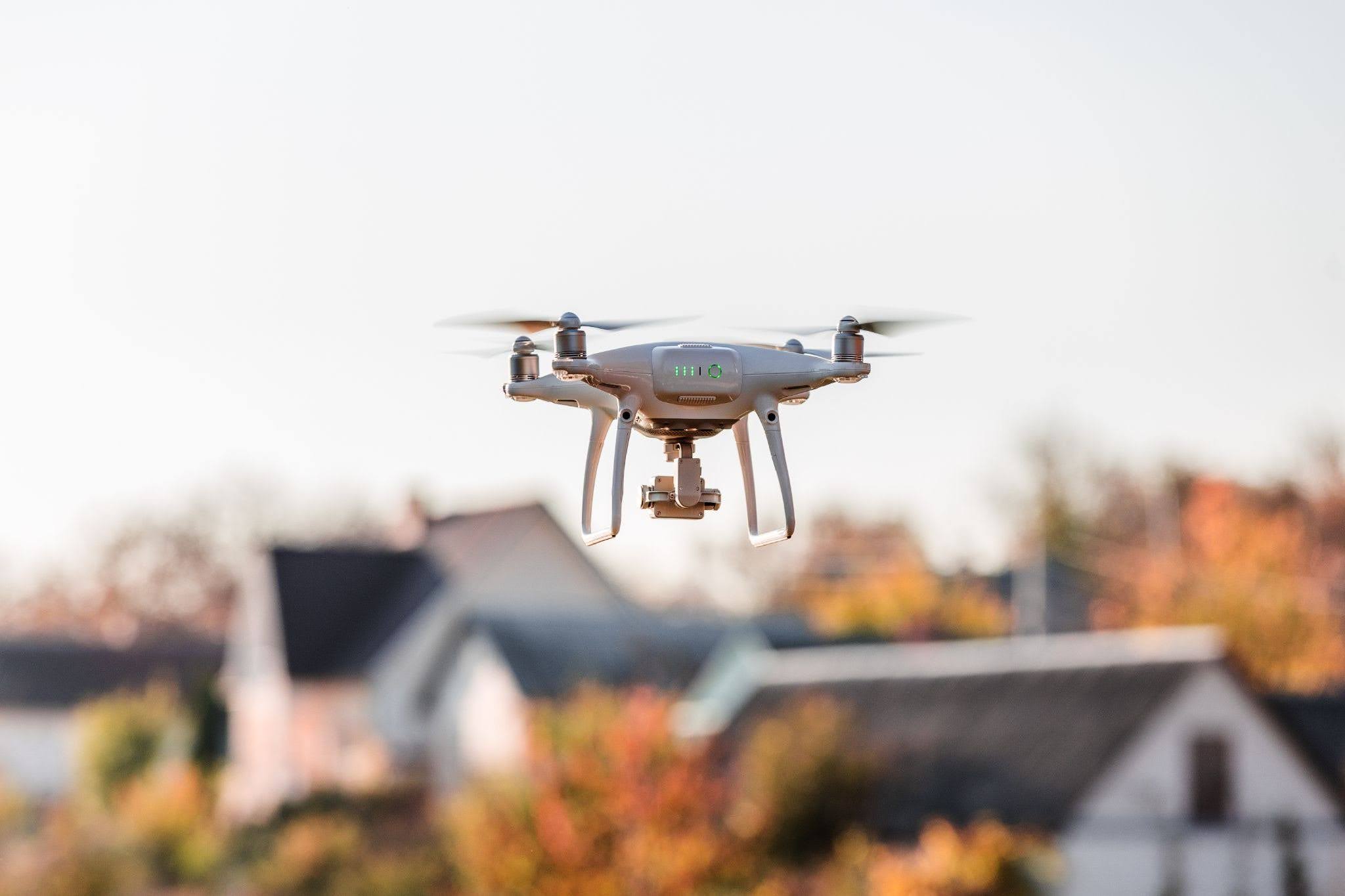 A photography drone flying in front of real estate properties