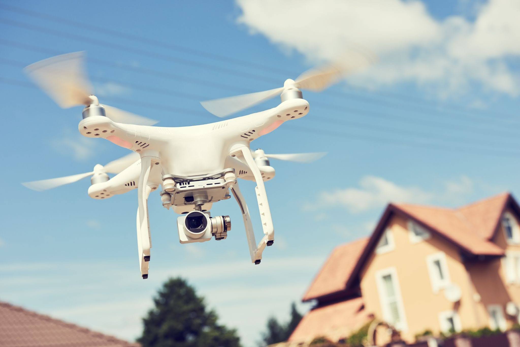A white drone used for real estate videography